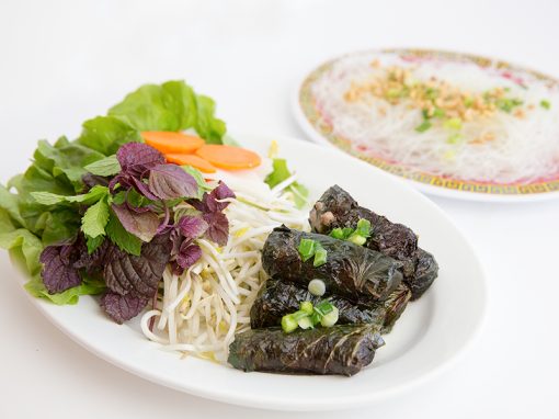 Grilled spicy beef wrapped in herb leaves served with vermicelli and rice paper